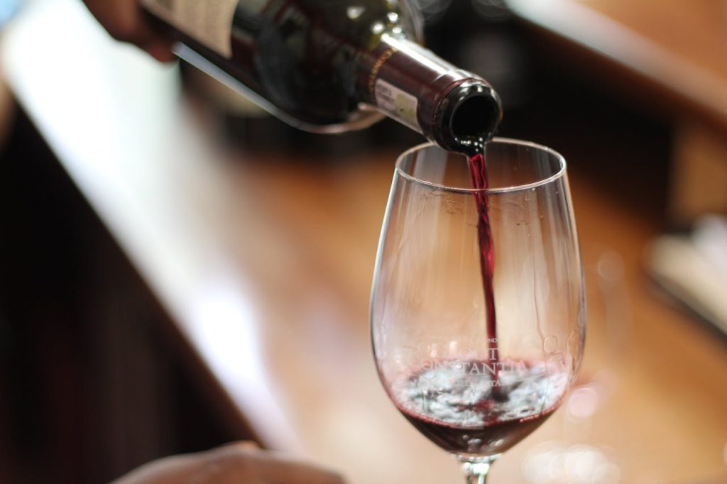 bouteille de vin ouverte qui sert un verre